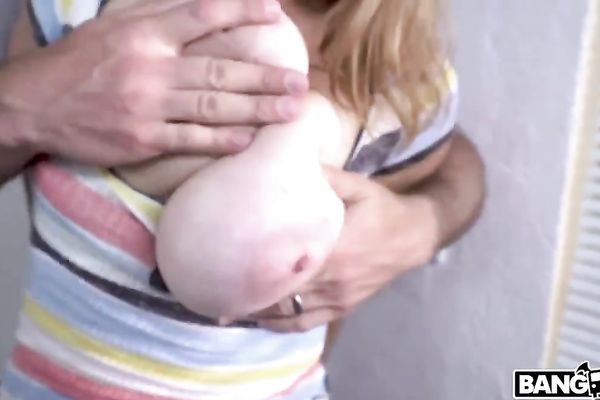 Lady with huge melons is sucking on the knees